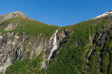 Fototapeta  - Geiranger Fjord in Norway with waterfalls cascading down the high mountains.