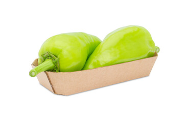 two green peppers in a cardboard basket