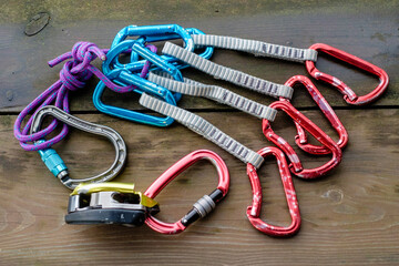 Climbing equipment on wooden background