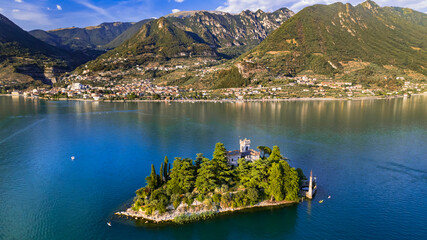 Wall Mural - Amazing lake Iseo scenery with picturesque small island Loreto with castle, aerial drone view. Italy, Brescia province