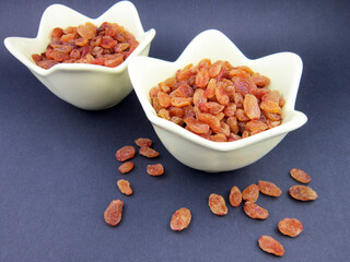 Wall Mural - two bowls of yellow golden raisins