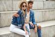 Leinwandbild Motiv Photo of attractive couple in stylish outfit wear hats posing outdoor