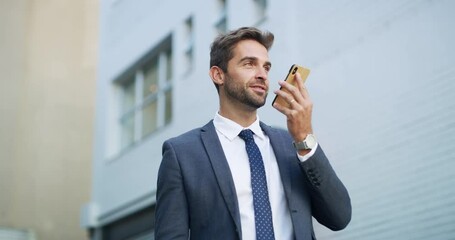 Wall Mural - Young, handsome and happy businessman on his phone recording a business memo in a suit in town. Caucasian executive in the city sending a note. Single and stylish worker using the voice assistant.
