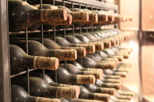 Dusty Wine Bottles In Italian Wine Cellar