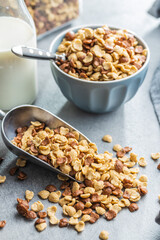 Sticker - Breakfast cereal flakes in scoop on kitchen table.