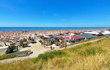 Zandvoort, Netherlands - August 12. 2022: View From Dunes On Crowded Dutch North Sea City Beach On Sunny Summer Weekend, Typical Pavillons