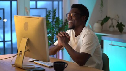 Successful African web developer coding new program, website or software. American programmer enjoy working from home on remote or freelance website or app project. Man communicating in social network
