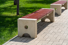 Stone Concrete Minimalist Benches With Wooden Logs, Outdoor Seating In Public Place. Long Benches With Wooden Seat For Pedestrians To Relax At City Park.