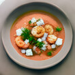 Hot Tomato soup with shrimp. Seafood creamy soup with goat cheese, olive powder, wild shrimps on bowl plate at wooden table, top view, close-up. Delicious vegetarian diet food.	