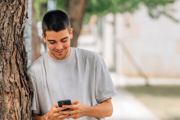 Sticker - young man in the street with mobile phone or smartphone