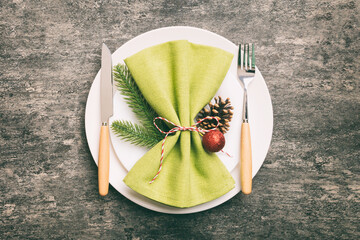 Sticker - Christmas table place setting with christmas decor and plates, kine, fork and spoon. Christmas holiday background. Top view with copy space