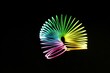 Closeup shot of a colorful slinky isolated on a black background