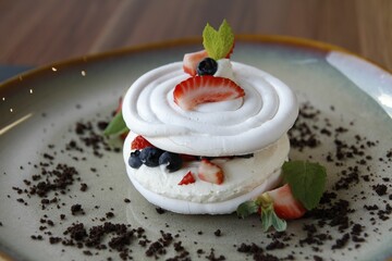 Poster - Closeup of a tasty Pavlova dessert with berries served on a plate