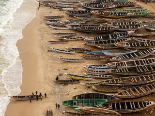 Wall Mural - Fishing boats and sailors in Nouakchott.