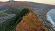 © Wirestock Creators - Aerial view of the Pink Pillbox hike route in Hawaii with gentle sea tides below at sunset