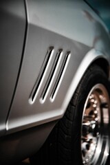 Sticker - Vertical selective focus on the detail of a grey retro sports car