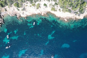 aerial view of boats near a rocky coastline