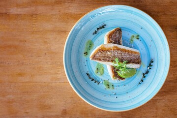 Wall Mural - Top view of a panfried wild barramundi fish served