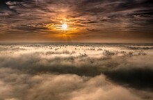 Beautiful Foggy Morning View With Clouds During Orange Sunset