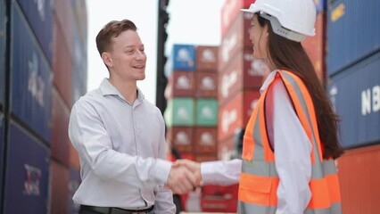 Wall Mural - Caucasian business male and female shake hand in container terminal.