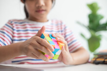 NAKHON RATCHASIMA, THAILAND - JULY 14, 2022:Asian Little Cute Girl Holding Rubik's Cube In Her Hands. Rubik's Cube Is A Game That Increases The Intelligence Of Children.