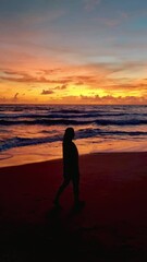 Wall Mural - women silhouette sunset on the tropical beach of Koh Lanta Thailand during a vacation in Thailand. Koh Lanta Island Thailand