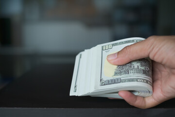 Wall Mural - Finger giving Cash 100 Dollar Closeup.Female Pay money is Expenditure from Bill Purchase or shopping.success income from loan. Plan Investment and save for 2023 New Year.Business or Finance Concept.