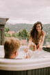 © BGStock72 - Young couple enjoying in outdoor hot tub on vacation