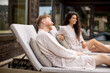 © BGStock72 - Young couple relaxing on beds  on the outdoor terrace