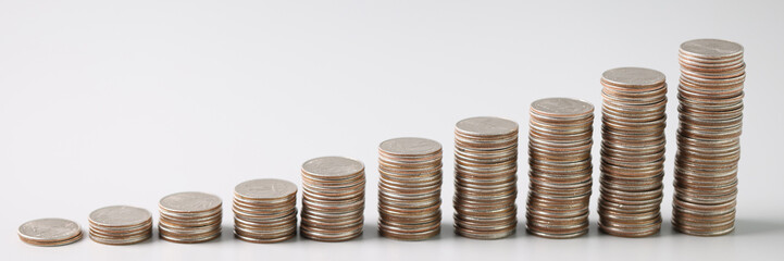 Wall Mural - Stacks of silver coins in ascending order on light gray background