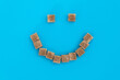 Smile face made of brown sugar cubes