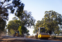 Road Roller And Grader Working On Country Road