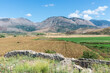 Idyllic landscape with agricultural fields surrounded by mountains in southern Albania near the abandoned Orthodox monastery