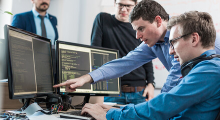 Wall Mural - startup business problem solving. software developers working on desktop computer.