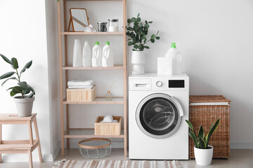 Wall Mural - Interior of light laundry room with washing machine, shelving unit and houseplants