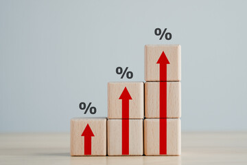 Interest rate finance and mortgage rates concept.  Wooden blocks with red arrow up and percentage sign, financial growth, interest rate increase, inflation, sale price and tax rise concept.