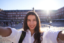 Happy Caucasian Woman Is Taking A Selfie Smiling At The Camera In Front Of The Equestrian Monument To King Felipe III Of Spain In The Plaza Mayor In Madrid