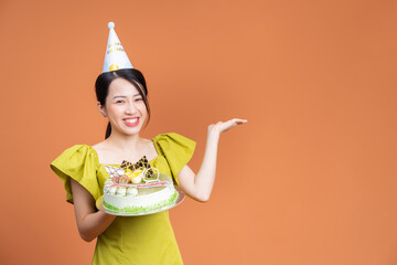 Wall Mural - Young Asian woman holding birthday cake