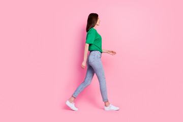 Sticker - Full body photo of lovely young girl walking shopping mall weekend promo dressed trendy green clothes isolated on pink color background