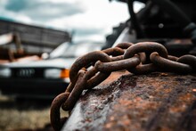 Closeup Shot Of Corroded Steel Chains On An Abandoned Car