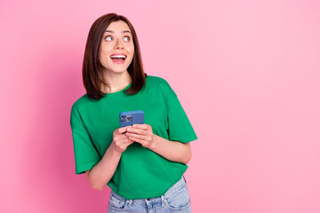 Sticker - Portrait of cheerful funky girl hold telephone look empty space offer isolated on pink color background