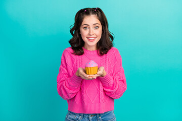 Poster - Photo of nice cute gorgeous girl wear pink pullover holding cupcake give you staring toothy beaming isolated on turquoise color background