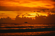 Sea Waving Against Cloudy Sunset Sky