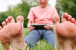 © ADDICTIVE STOCK - Barefoot child browsing cellphone on lawn