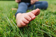© ADDICTIVE STOCK - Crop child sitting on grass