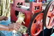 Making of Sugarcane juice through manual extracting of pulp from the sugarcane. Sugarcane juice making from the machine during summer season in Tamilnadu.