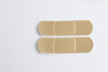 plastic adhesive band aids, patch medical band, various colors and material. isolated on white backg