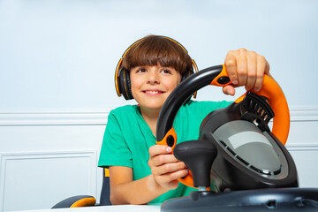 Wall Mural - Portrait with steering wheel of a gamer young boy playing game