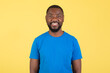 © Prostock-studio - Portrait Of Toothy African American Guy Posing Over Yellow Background