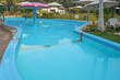 © polack - Empty childrens pool. Childrens swimming pool with sunny reflections